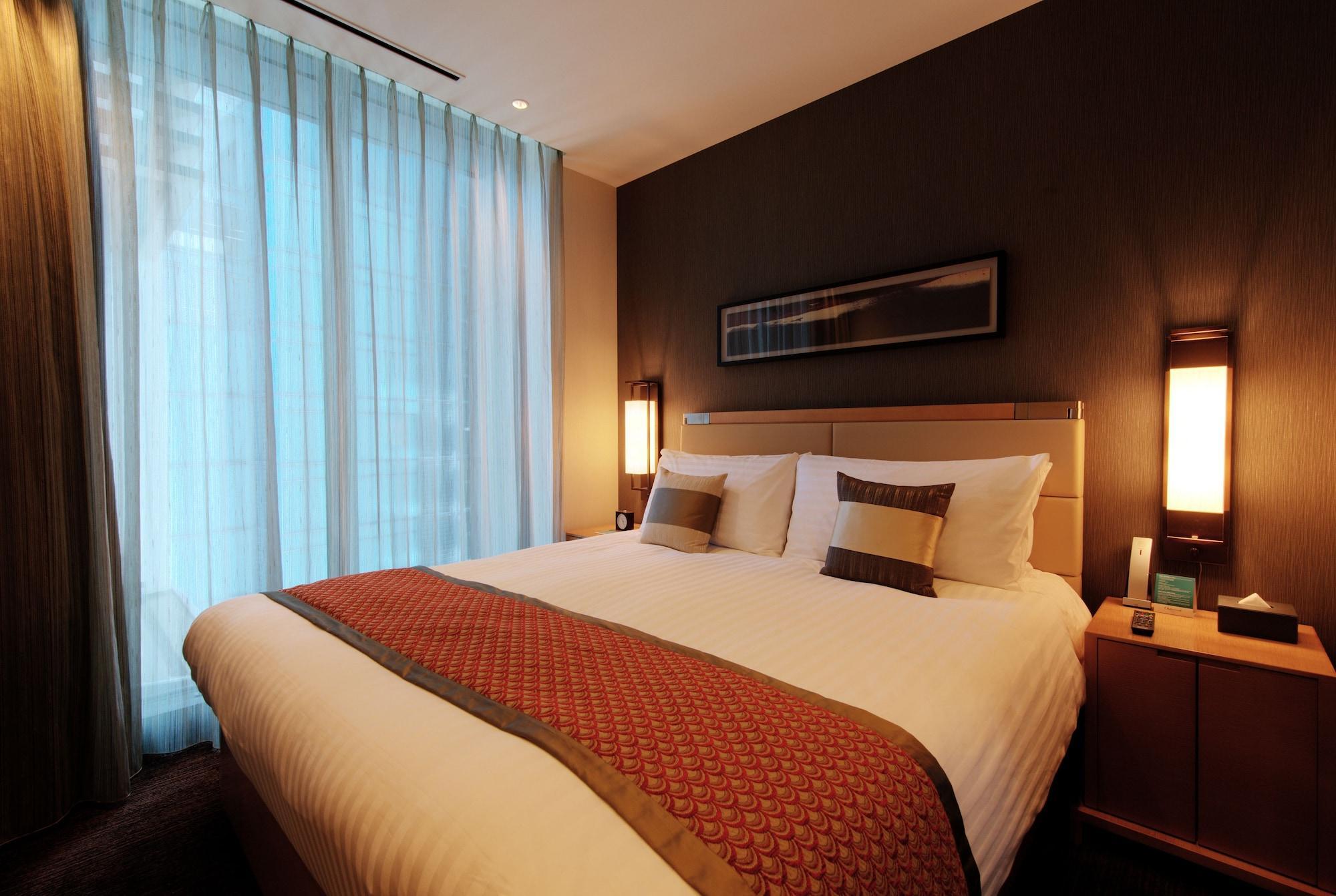 Oakwood Premier Tokyo Hotel Buitenkant foto A bedroom in a hotel